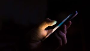 Person holding smartphone with VPN